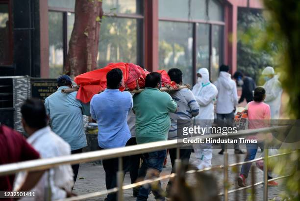 Relatives of a person who died of Covid-19 carry the body for cremation at Nigambodh Ghat crematorium, on April 24, 2021 in New Delhi, India.