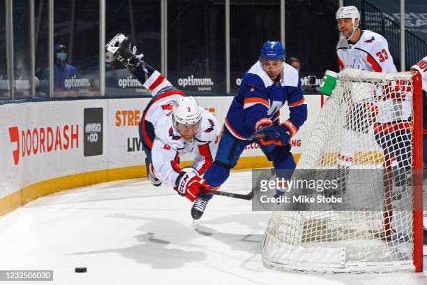Nick Jensen of the Washington Capitals gets tripped up against Jordan Eberle of the New York Islanders during the first period at Nassau Coliseum on...