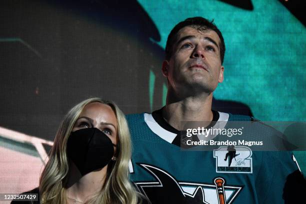 Patrick Marleau of the San Jose Sharks and his wife Christina Marleau look up at the video board as he is honored for having passed Gordie Howe on...