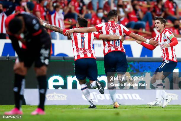 Angel Saldívar of Chivas celebrates with his teammates after scoring the first goal of his team during the 16th round match between Atlas and Chivas...