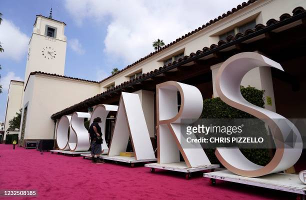 An Academy Awards crew member looks over a background element for the red carpet at Union Station, one of the locations for Sunday's 93rd Academy...