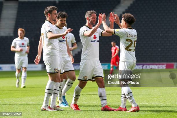 Will Grigg celebrates with team mates after scoring for Milton Keynes Dons, to extend their lead making it 5 - 0 against Swindon Town, during the Sky...