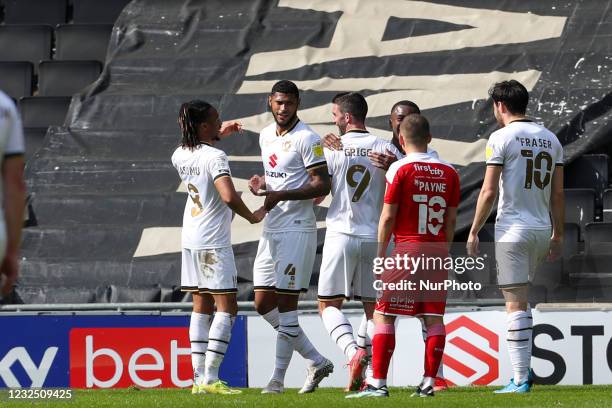 Will Grigg celebrates with team mates after scoring for Milton Keynes Dons, to extend their lead making it 3 - 0 against Swindon Town, during the Sky...