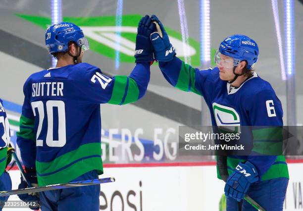 Brock Boeser and Brandon Sutter of the Vancouver Canucks celebrate their win over the Ottawa Senators at Rogers Arena on April 24, 2021 in Vancouver,...