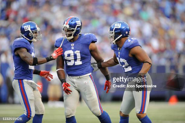 New York Giants defensive end Justin Tuck reacts after sacking Washington Redskins quarterback Jason Campbell with safety Kenny Phillips and...