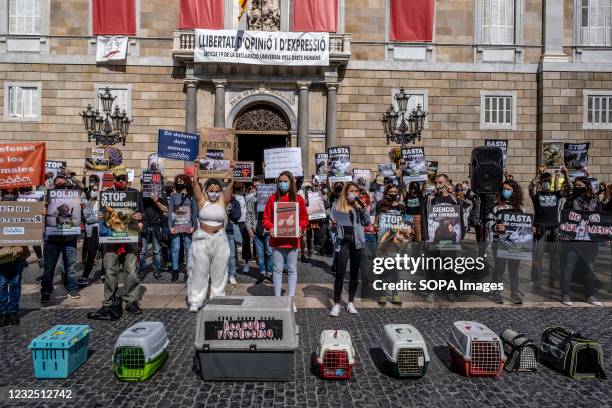 Activists against animal cruelty hold placards during the demonstration. A hundred people have gathered in Plaza de Sant Jaume to condemn the cruelty...