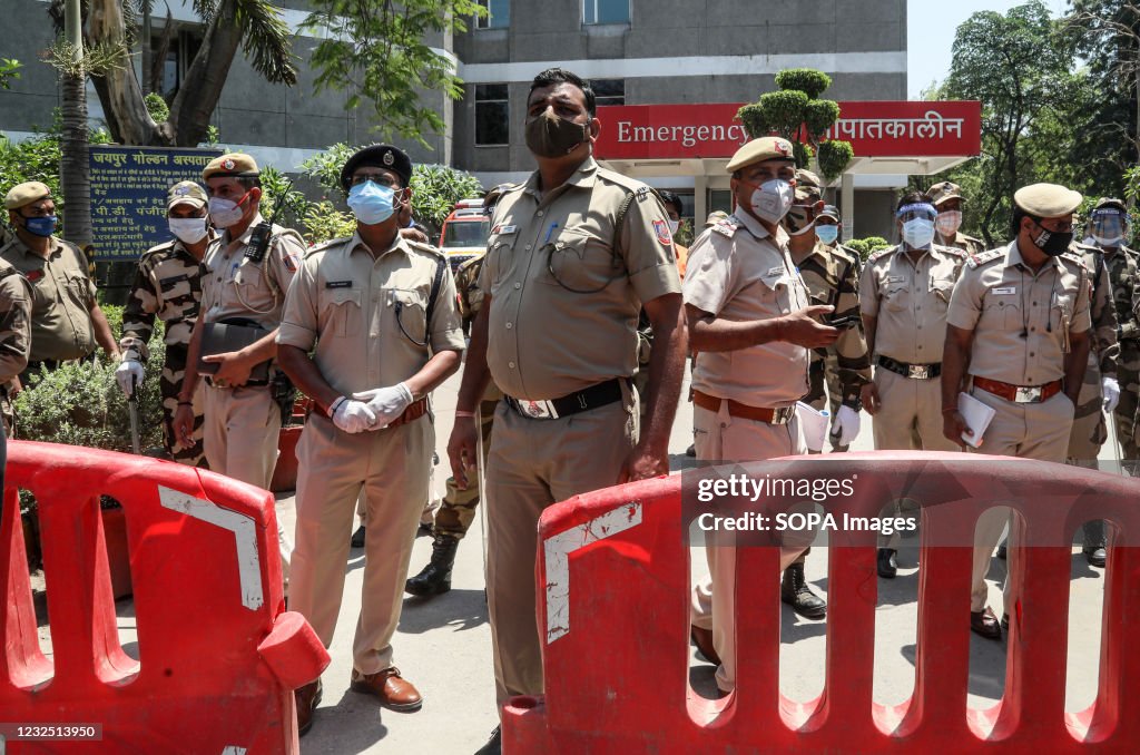 Delhi Police officers stand on guard for any clash between...