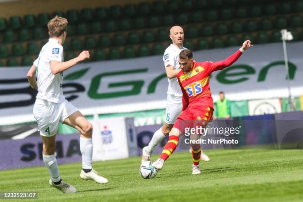 Esus Imaz , Lukasz Tralka and Robert Ivanov in action during Polish Football Extraleague match between Warta Poznan and Jagiellonia Bialystok in...