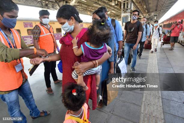 Helth workers are seen marking quarantine stamp on the travelers hand who travel from kerala to Mumbai at lokmanya tilak terminus after increase...