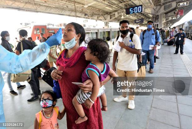 Healthcare worker collects swab samples of passengers at lokmanya tilak terminus, on April 25, 2021 in Mumbai, India.
