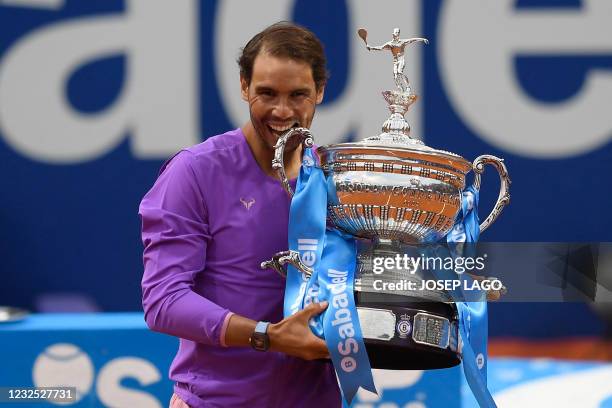 Spain's Rafael Nadal celebrates with the trophy after winning the ATP Barcelona Open tennis tournament singles final match against Greece's Stefanos...