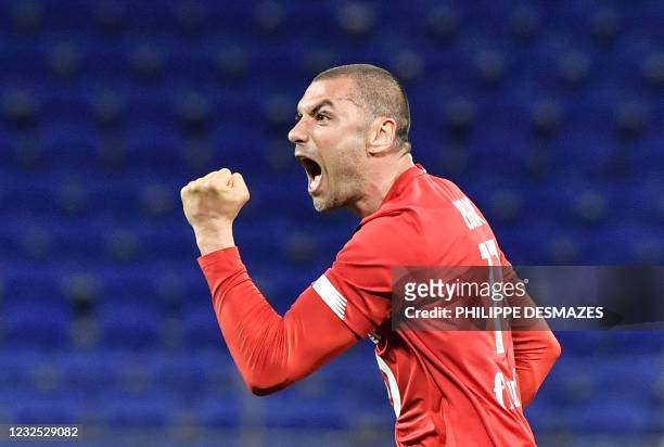 Lille's Turkish forward Burak Yilmaz reacts after scoring during the French Ligue 1 football match between Olympique Lyonnais and LOSC Lille at the...