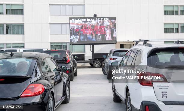 People attend the Sunset Strip Late Night Drive-In Oscars Watch Party On the parking lot of the Andaz Hotel, April 25, 2021 in West Hollywood,...