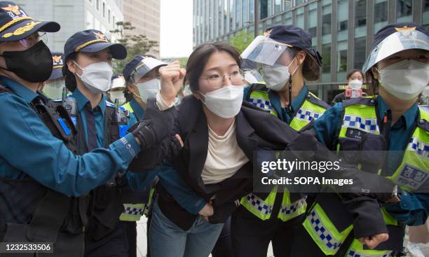 Police officers detain a student protester during an anti-Japan protest near the Japanese Embassy in Seoul. Japan recently decided to start...