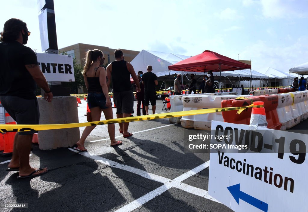 People arrive at the FEMA-supported COVID-19 vaccination...