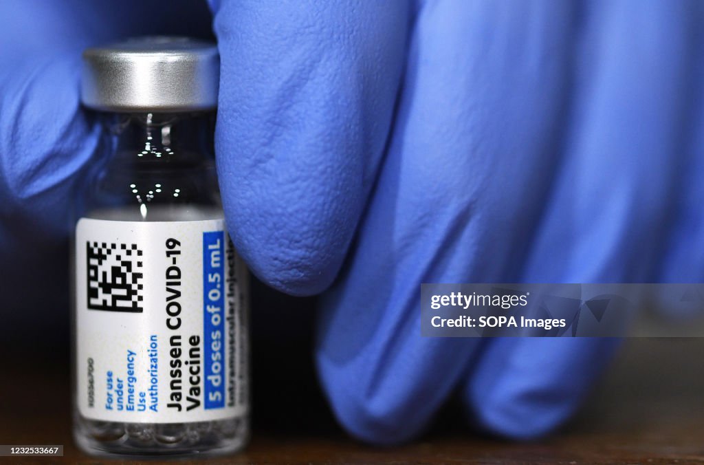 An Army nurse holds a vial of the Johnson & Johnson vaccine...