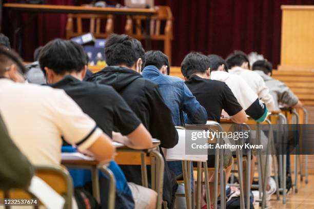 Students sit for the Diploma of Secondary Education exams on April 26, 2021 in Hong Kong, China. Temperature checks and social distancing measures to...