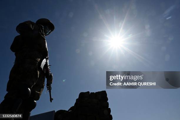 Pakistani soldier stands guard on a post near the Line of Control, de facto border between India and Pakistan at Salohi village in Poonch district of...