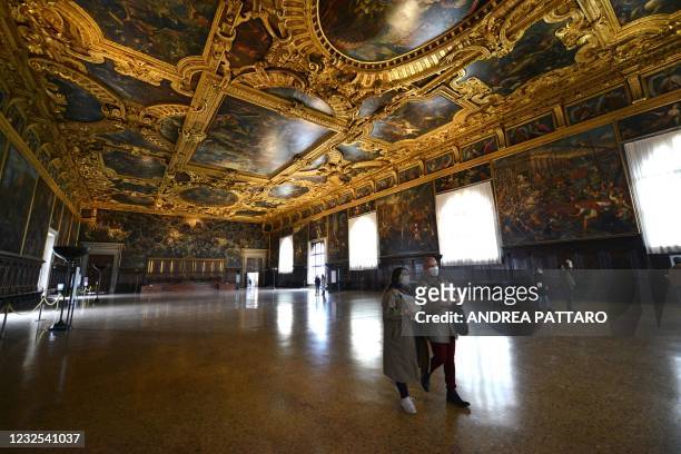 People visit the Palazzo Ducale on the day of its reopening, in Venice on April 26, 2021. - Bars, restaurants, cinemas and concert halls will...