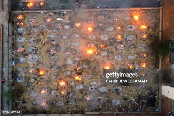 In this aerial picture taken on April 26 burning pyres of victims who lost their lives due to the Covid-19 coronavirus are seen at a cremation ground...