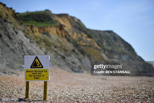 An advisory notice is seen on the beach close to the scene of a coastal cliff fall on Dorset's Jurassic Coast near the village of Seatown, on the...