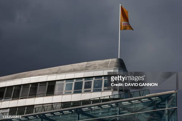 Photo taken on April 26, 2021 shows the party's logo on a flag fluttering in the breeze on the roof of the headquarters of the Christian Democratic...