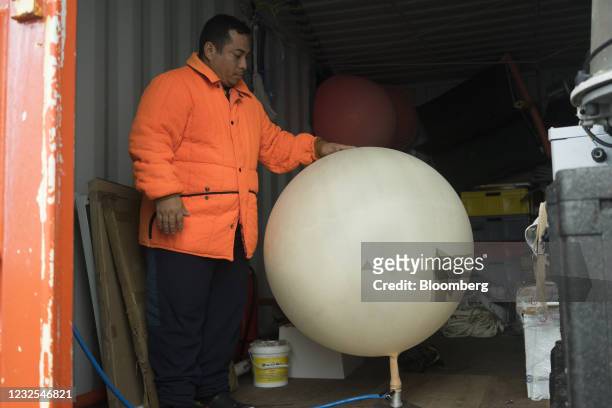 Marine meteorologist prepares to deploy weather balloons to measure atmospheric conditions near Ecuador's Pedro Vicente Maldonado Research Station on...