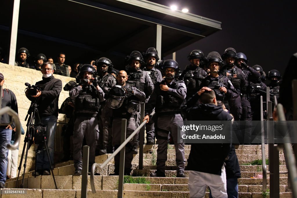 Israeli police disperse a group of Palestinians after unfurling flag