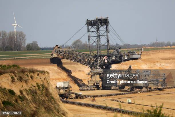 April 2021, North Rhine-Westphalia, Erkelenz: An excavator removes soil at the Garzweiler opencast mine. The state government of North...