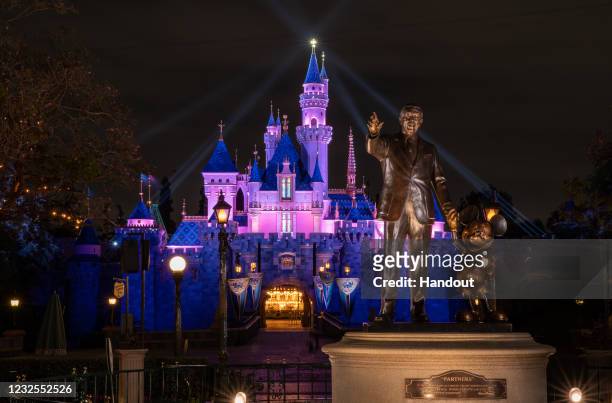 In this handout photo provided by Disneyland Resort, a view of Sleeping Beauty Castle in Disneyland Park illuminated during a special live streamed...