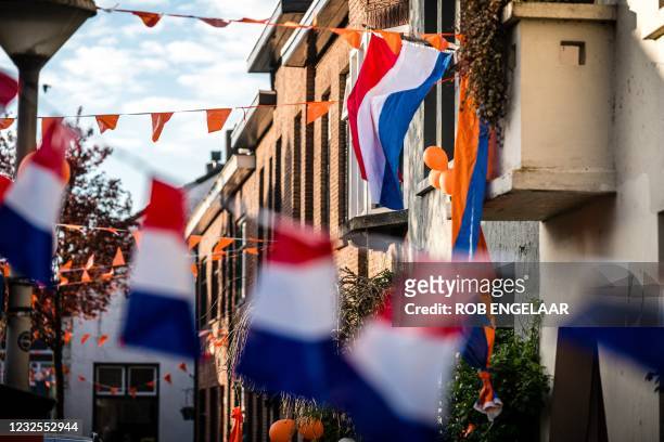 Street is decorated with flags in the centre of Eindhoven during the celebration of King's Day, in Eindhoven, the Netherlands, on April 27, 2021. -...