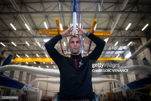 French skipper Armel Le Cleac'h poses in front of the new Banque Populaire XI Ultim multihull sailing boat, on the eve of its launch in Lorient,...