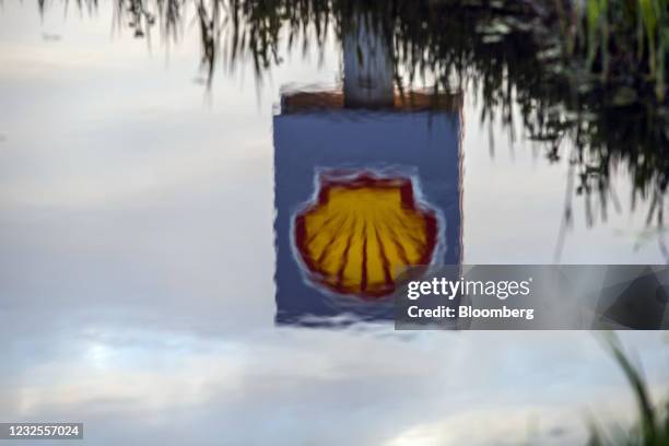 Royal Dutch Shell Plc logo reflected in a pond at a gas station in Rotterdam, Netherlands, on Tuesday, April 27, 2021. Shell reports first quarter...