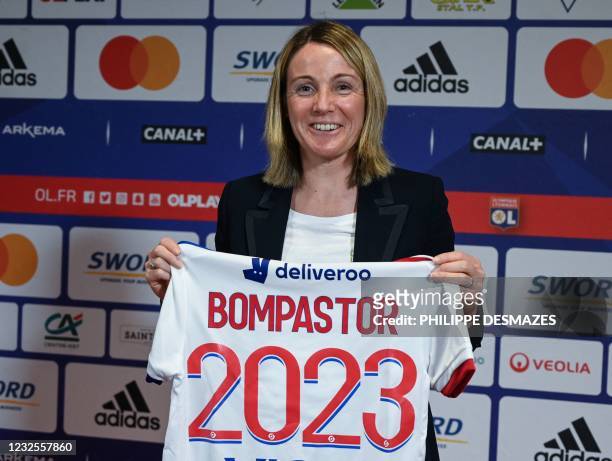 French football coach Sonia Bompastor poses with a team jersey during a press conference after she was appointed Lyon's women team new head coach, in...