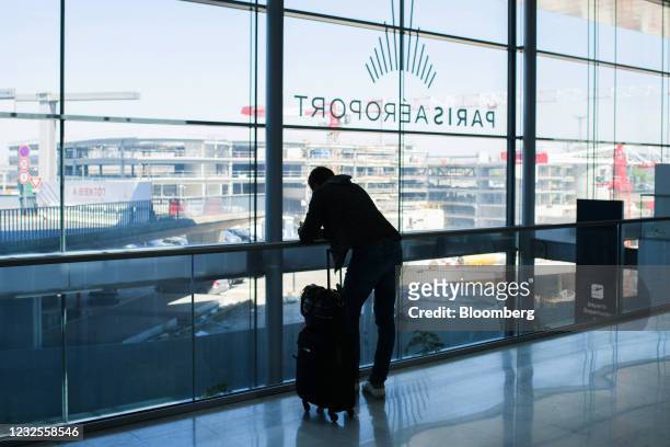 Traveler uses a smartphone in Terminal 3 at Orly Airport, operated by Aeroports de Paris, in Paris, France, on Tuesday, April 27, 2021. France is...