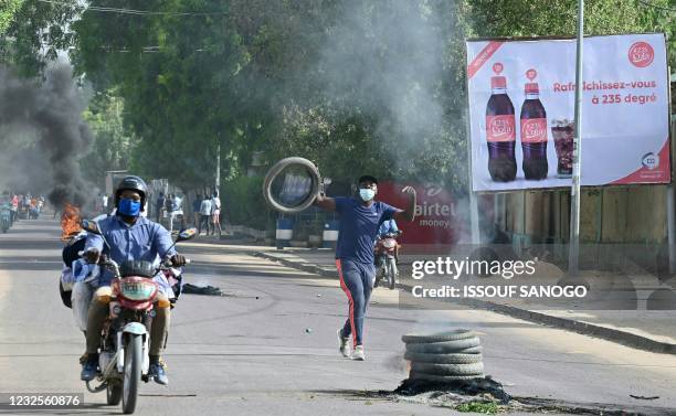 Demonstrators burn tyres in the street during clashes with Chadian police in N'Djamena on April 27, 2021. - At least five people were killed on April...