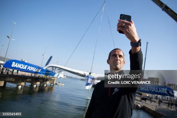 French skipper Armel Le Cleac'h takes a selfie during the launching of the new Banque Populaire XI Ultim multihull in Lorient, western France on...