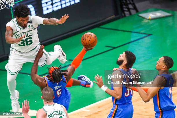 Marcus Smart of the Boston Celtics fouls Luguentz Dort of the Oklahoma City Thunder during a game at TD Garden on April 27, 2021 in Boston,...