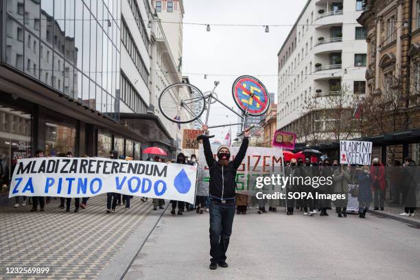 Protester lifts up a bicycle with a no to fascism symbol, as he heads a procession of protesters during the demonstration. Protests against the...