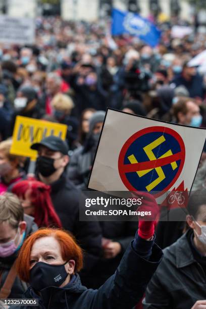 Protester holding a placard with a 'No to fascism' symbol during the demonstration. Protests against the government of Janez Jansa in Slovenia...
