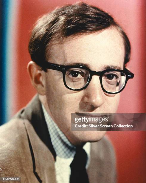 Woody Allen, US comedian, film director and actor, wearing a brown jacket, a fine check shirt and a black tie, and his trademark horn-rimmed...