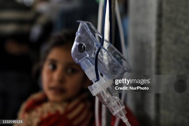 Girl who was put on ventilator after tested Positive for COVID-19 looks towards the Oxygen mask after she received Oxygen support at a COVID-19...