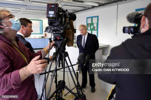 Britain's Prime Minister Boris Johnson, answers questions from the media after taking part in a science lesson at King Solomon Academy in London, on...