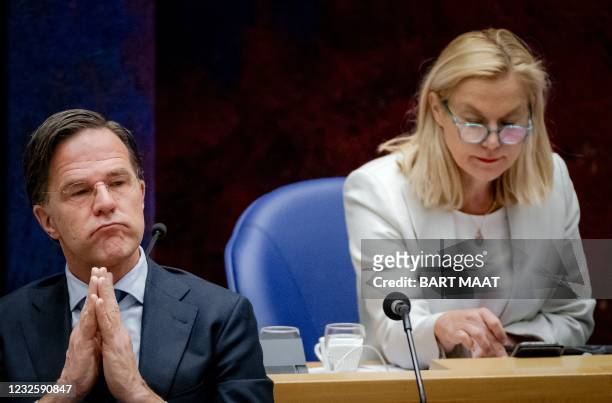 Outgoing Prime Minister Mark Rutte and outgoing Minister of Foreign Trade Sigrid Kaag listen on during a new debate on the benefits affair in the...