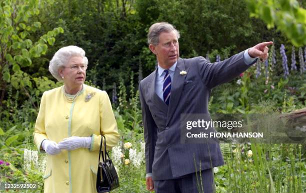 Britain's Queen Elizabeth II and the Prince of Wales look at the 'Healing Garden', 20 May 2002, which was designed by the Prince in conjunction with...