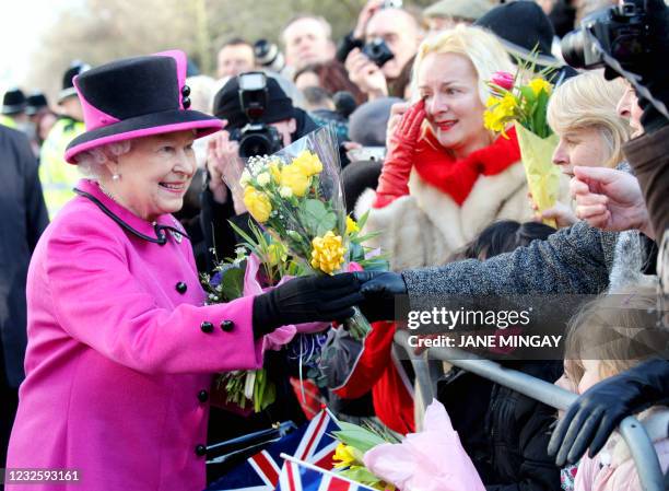 Britain's Queen Elizabeth II greets the crowd after visiting the Warwickshire Justice Centre in Leamington Spa on March 4, 2011. AFP PHOTO / POOL /...