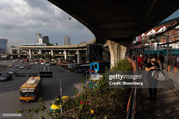 Pedestrians walk past the BTS Skytrain at Democracy Monument in Bangkok, Thailand, on Thursday, April 29, 2021. Thailand is reworking its vaccine...