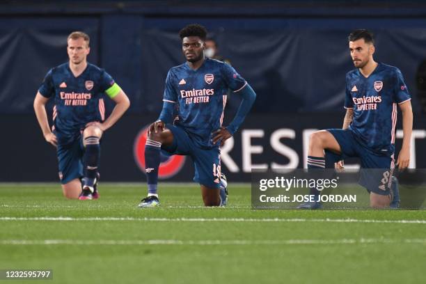 Arsenal's English defender Rob Holding, Arsenal's Ghanaian midfielder Thomas Partey and Arsenal's Spanish midfielder Dani Ceballos take a knee before...