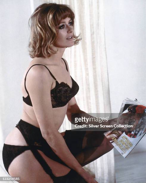 Vanessa Redgrave, British actress, wearing black underwear and holding an Italian magazine, circa 1966.
