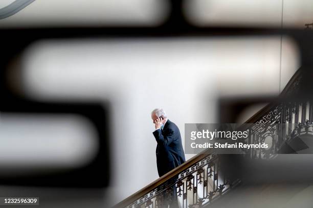 Sen. Ron Johnson speaks on the phone while departing Senate Republican policy luncheons at the Russell Senate Office Building on April 29, 2021 in...